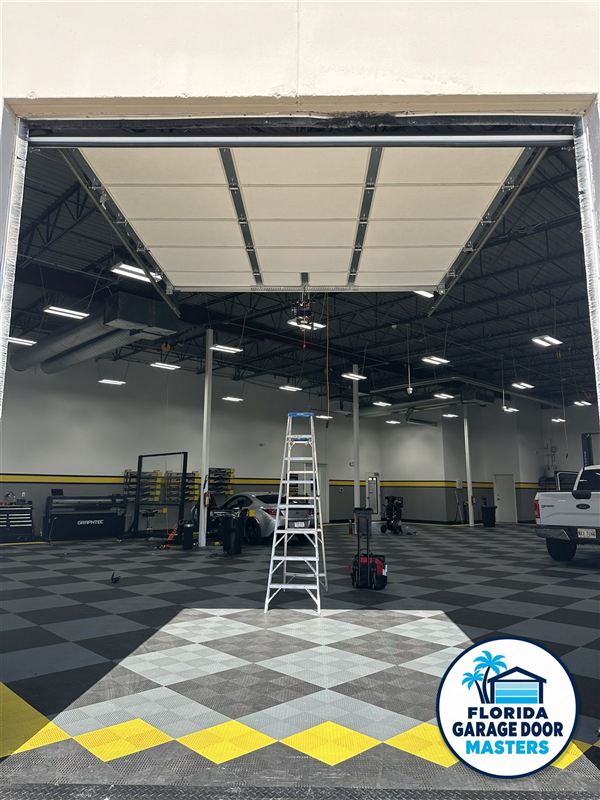 Large commercial overhead door opening into a warehouse