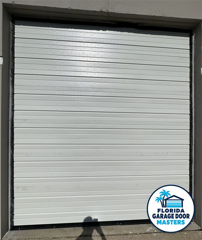 White commercial sectional overhead door, closed