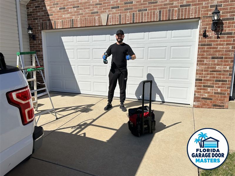 Florida Garage Door Masters technician in front of a finished garage door