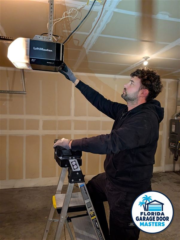 Technician installing a smart Wi-Fi LiftMaster garage door opener